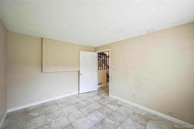 9642 W Chatfield Ave Unit A, Littleton, CO 80128 - unfurnished room featuring baseboards and a textured ceiling