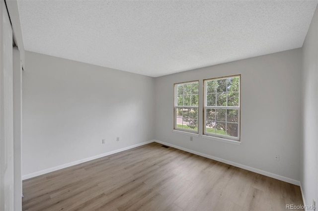 9642 W Chatfield Ave Unit A, Littleton, CO 80128 - empty room with wood finished floors and a textured ceiling