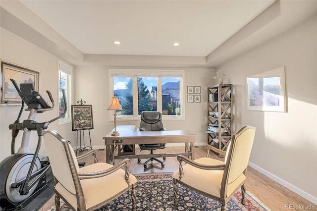 home office featuring wood finished floors, baseboards, a raised ceiling, and recessed lighting