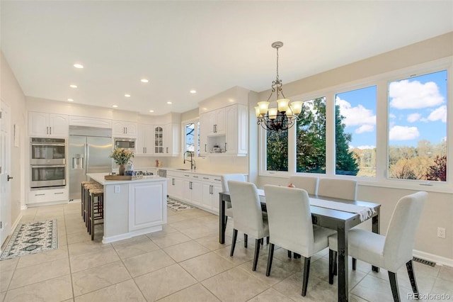 dining room featuring a wealth of natural light, recessed lighting, a chandelier, and light tile patterned flooring