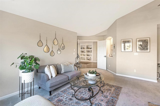 living room featuring built in features, baseboards, arched walkways, and carpet floors