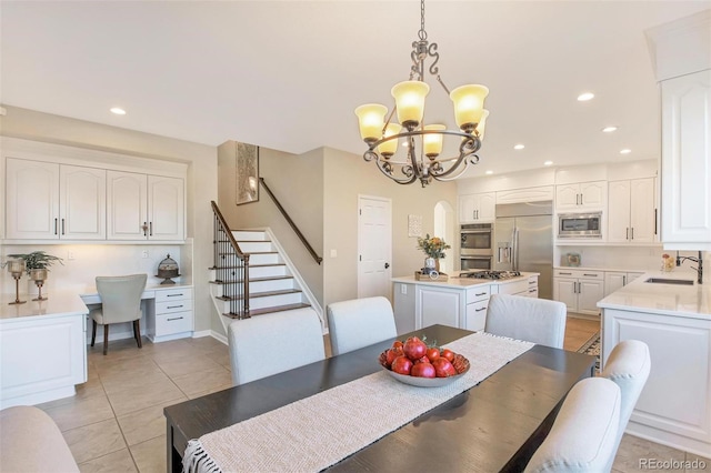dining area featuring light tile patterned floors, a notable chandelier, recessed lighting, and stairway