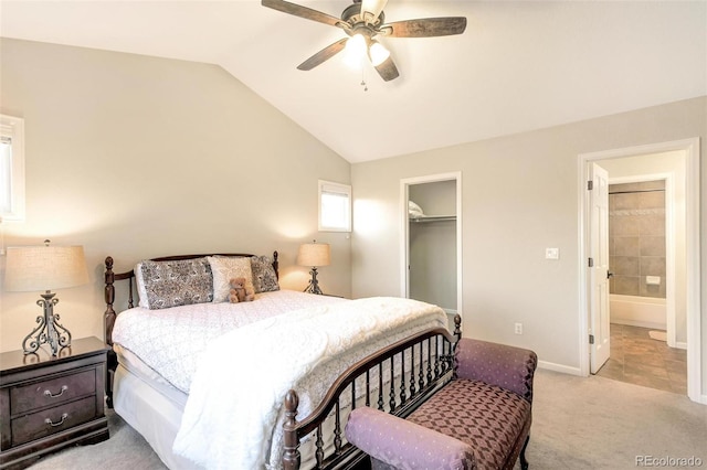 carpeted bedroom with a closet, baseboards, ceiling fan, lofted ceiling, and a spacious closet