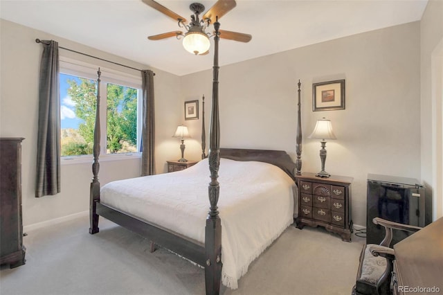 carpeted bedroom with baseboards and a ceiling fan