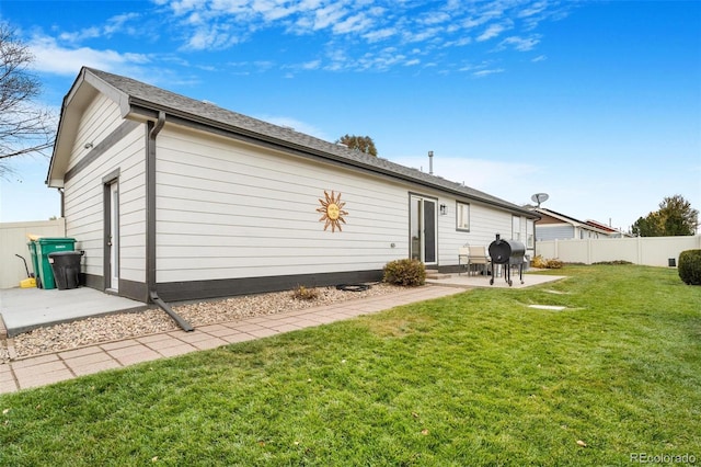 rear view of house with a yard and a patio area