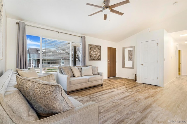 living room with light hardwood / wood-style floors, vaulted ceiling, and ceiling fan