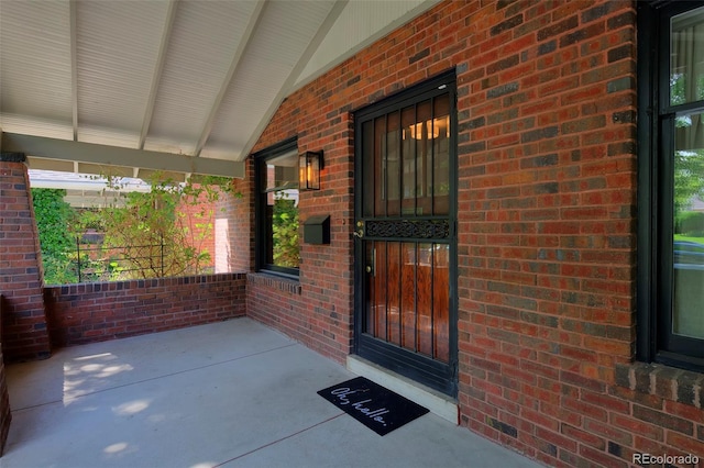 3237 N Josephine St, Denver, CO 80205 - doorway to property featuring covered porch and brick siding