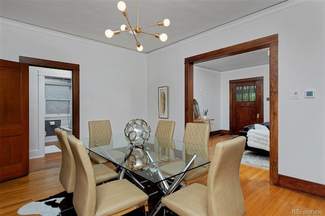 3237 N Josephine St, Denver, CO 80205 - dining room with a chandelier, crown molding, and light wood-style floors