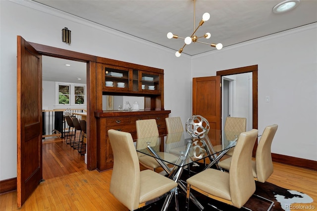 3237 N Josephine St, Denver, CO 80205 - dining room featuring a chandelier, light wood-style floors, and crown molding