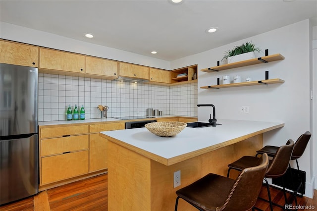 3237 N Josephine St, Denver, CO 80205 - kitchen featuring freestanding refrigerator, a peninsula, dark wood-style flooring, light countertops, and tasteful backsplash