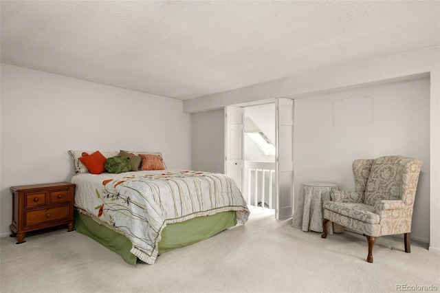 bedroom with carpet and a textured ceiling