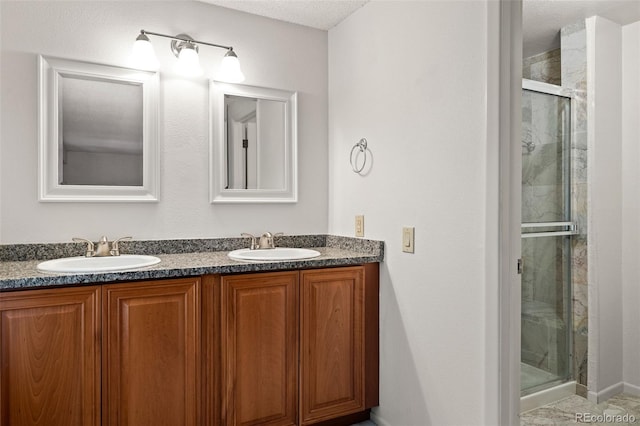 bathroom featuring a shower stall and double vanity