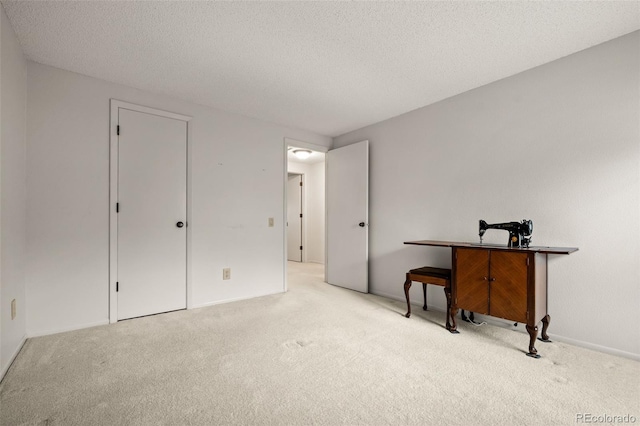 bedroom featuring carpet flooring, a textured ceiling, and baseboards