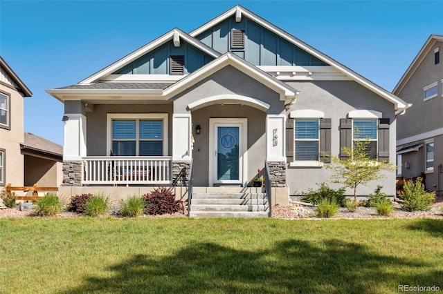763 Sage Forest Ln, Monument, CO 80132 - craftsman house featuring a front lawn, board and batten siding, stucco siding, and stone siding