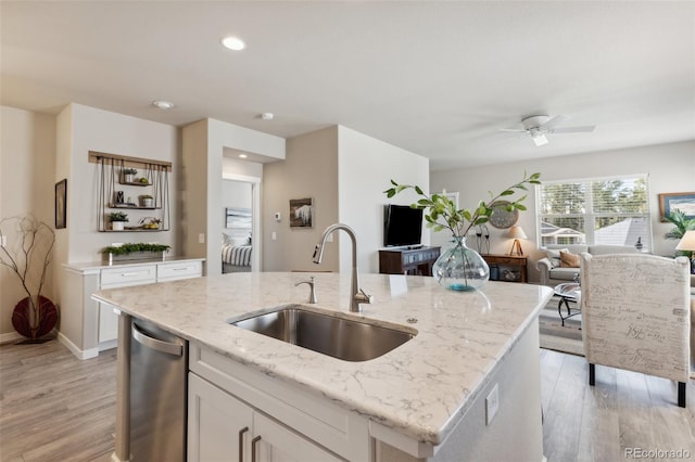 763 Sage Forest Ln, Monument, CO 80132 - kitchen featuring a sink, open floor plan, light wood finished floors, light stone countertops, and recessed lighting