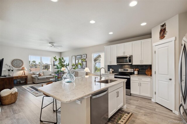 763 Sage Forest Ln, Monument, CO 80132 - kitchen featuring stainless steel appliances, a sink, healthy amount of natural light, light wood-style flooring, and recessed lighting