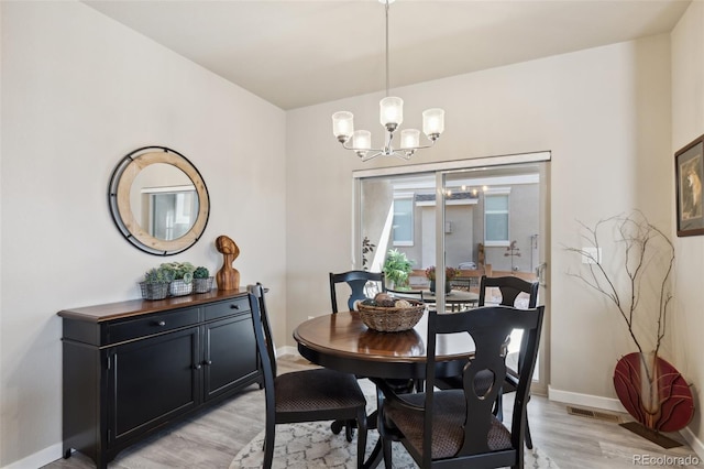 763 Sage Forest Ln, Monument, CO 80132 - dining area featuring a chandelier, light wood-type flooring, and baseboards