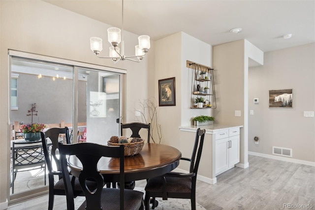 763 Sage Forest Ln, Monument, CO 80132 - dining room featuring a chandelier, light wood finished floors, and baseboards