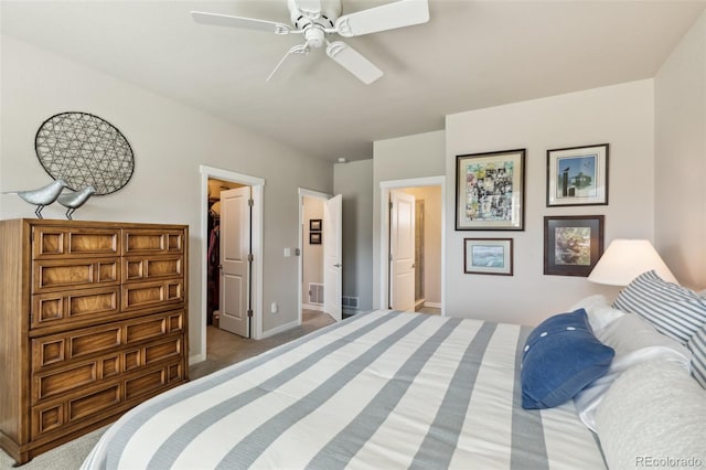 763 Sage Forest Ln, Monument, CO 80132 - bedroom featuring a spacious closet, light colored carpet, baseboards, ceiling fan, and connected bathroom