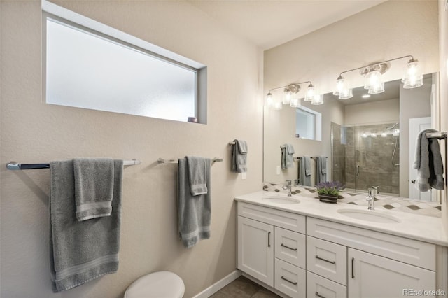 763 Sage Forest Ln, Monument, CO 80132 - bathroom featuring double vanity, a stall shower, toilet, and baseboards