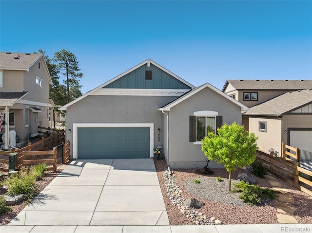 763 Sage Forest Ln, Monument, CO 80132 - view of front of house with an attached garage, concrete driveway, stucco siding, and board and batten siding