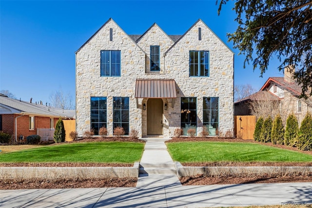 view of front facade with fence and a front lawn