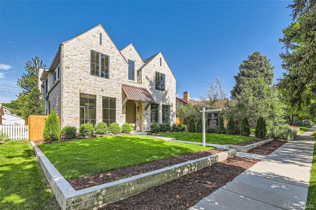 2365 S Clayton St, Denver, CO 80210 - view of front of property featuring stone siding, a standing seam roof, and a metal roof