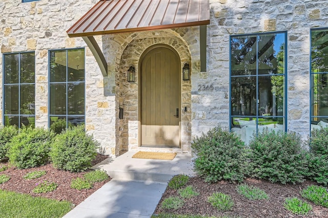 2365 S Clayton St, Denver, CO 80210 - entrance to property featuring a standing seam roof, stone siding, and a metal roof