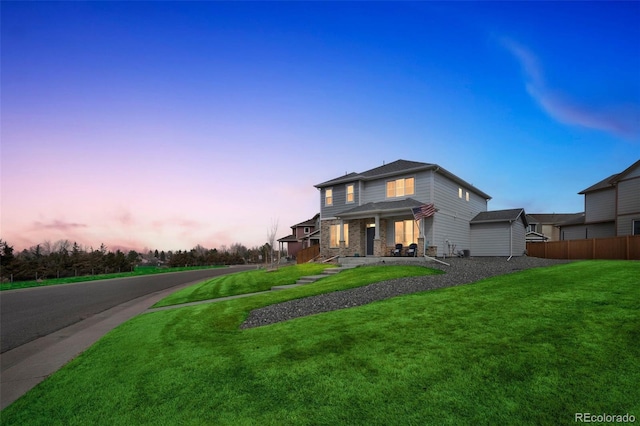 view of front of home featuring a front lawn and fence
