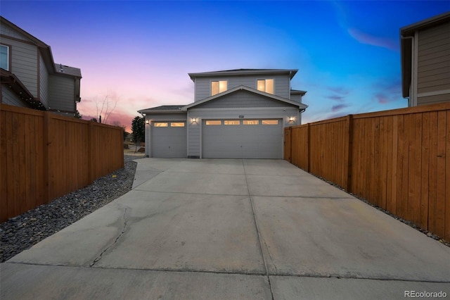 garage with driveway and fence