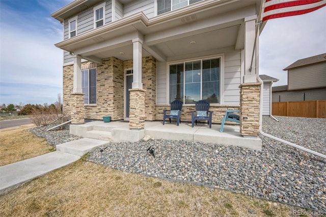 view of patio with covered porch and fence