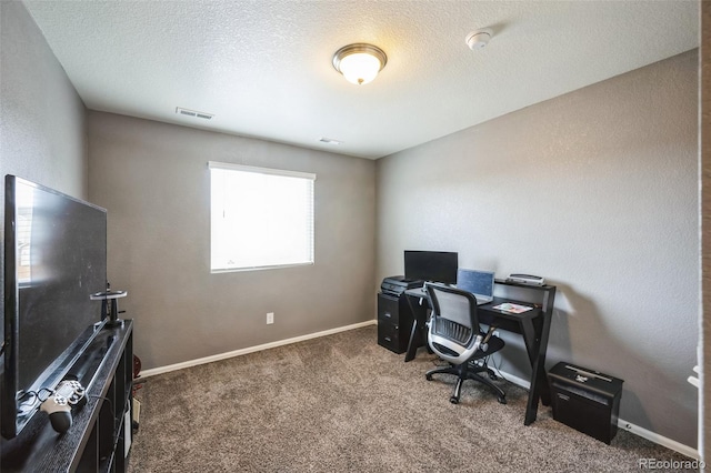 carpeted office space with baseboards, visible vents, and a textured ceiling