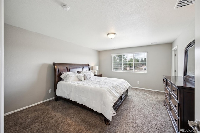 carpeted bedroom featuring visible vents, baseboards, and a textured ceiling