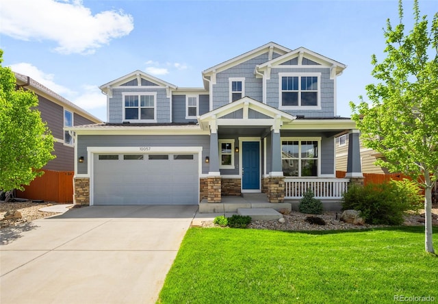 10057 Des Moines St, Parker, CO 80134 - craftsman-style home with a porch, driveway, stone siding, and an attached garage