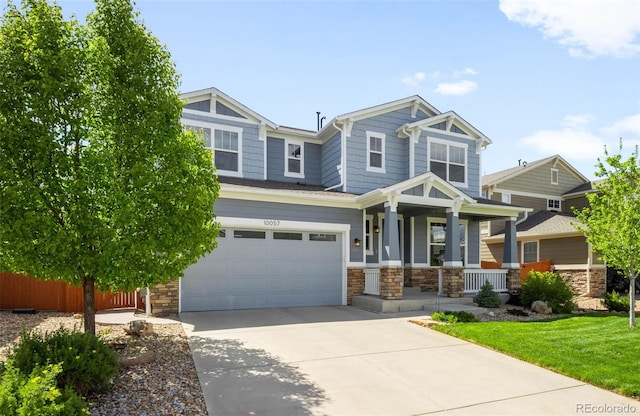 10057 Des Moines St, Parker, CO 80134 - craftsman house with covered porch, stone siding, driveway, and an attached garage