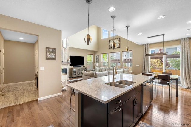 10057 Des Moines St, Parker, CO 80134 - kitchen with a sink, wood-type flooring, dishwasher, a center island with sink, and decorative light fixtures