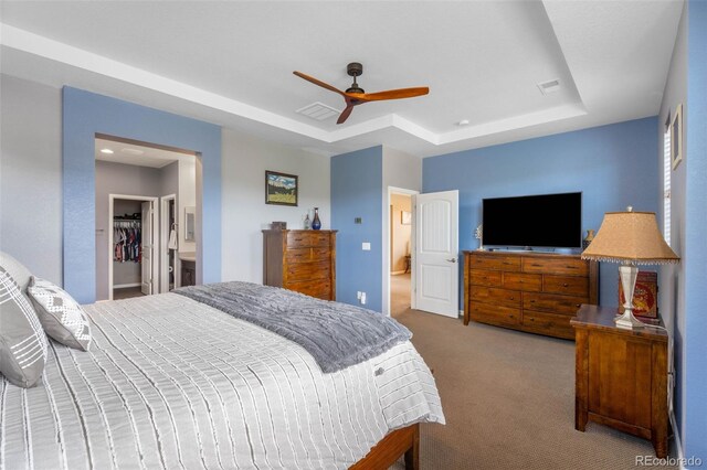 10057 Des Moines St, Parker, CO 80134 - bedroom featuring a raised ceiling, carpet, a walk in closet, a ceiling fan, and a closet