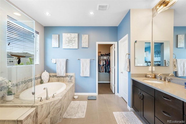 10057 Des Moines St, Parker, CO 80134 - full bath featuring vanity, baseboards, a walk in closet, a bath, and tile patterned flooring