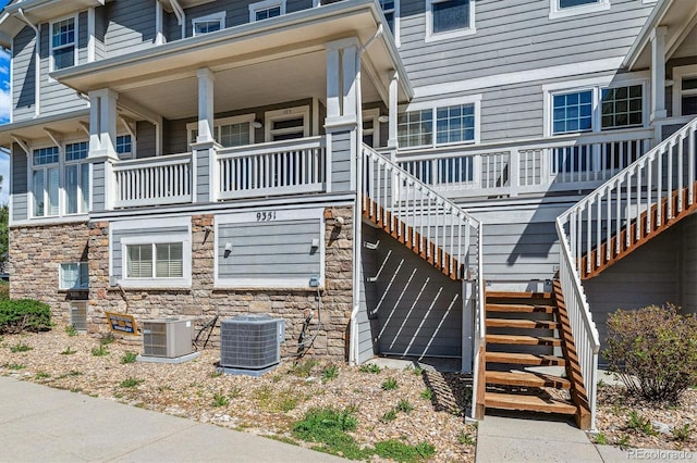 view of property with central AC unit and stairway