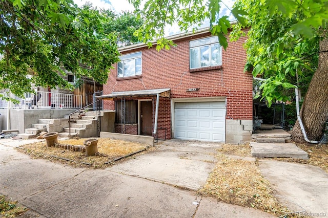 2635 W 24th Ave, Denver, CO 80211 - townhome / multi-family property with an attached garage, driveway, and brick siding