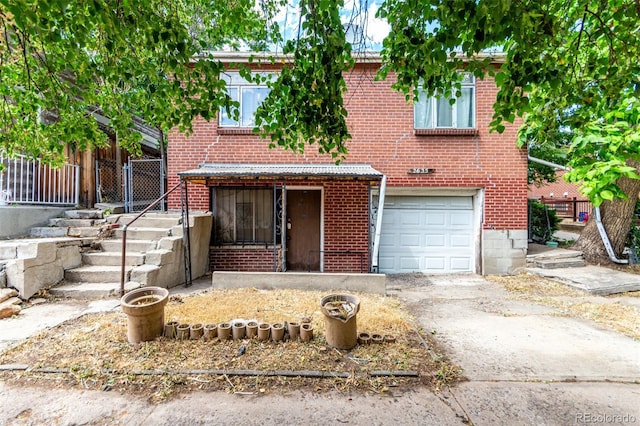 2635 W 24th Ave, Denver, CO 80211 - view of front of home featuring driveway, brick siding, and an attached garage