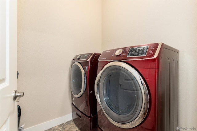 clothes washing area with washing machine and dryer and light tile patterned flooring