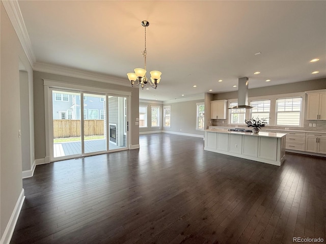 6023 Chester Way, Denver, CO 80238 - unfurnished living room with crown molding, dark wood-style floors, a chandelier, plenty of natural light, and baseboards