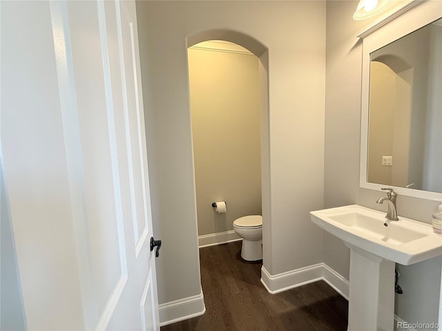 6023 Chester Way, Denver, CO 80238 - bathroom with toilet, wood finished floors, and baseboards