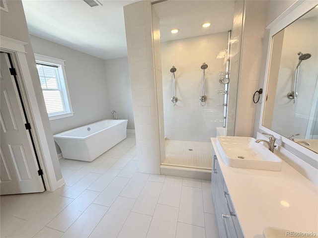 6023 Chester Way, Denver, CO 80238 - bathroom with a shower stall, a freestanding bath, vanity, recessed lighting, and tile patterned flooring