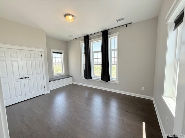 6023 Chester Way, Denver, CO 80238 - unfurnished bedroom with dark wood finished floors, baseboards, and a closet