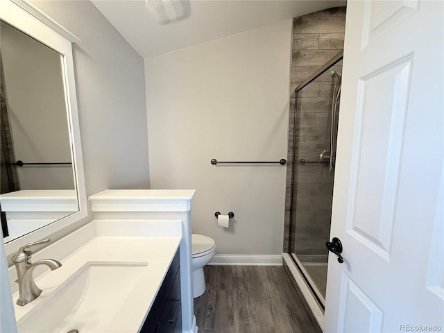 6023 Chester Way, Denver, CO 80238 - bathroom featuring toilet, vanity, a stall shower, wood finished floors, and baseboards