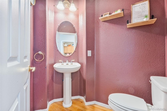24022 E Jamison Dr, Aurora, CO 80016 - bathroom featuring toilet, wood finished floors, and a textured wall