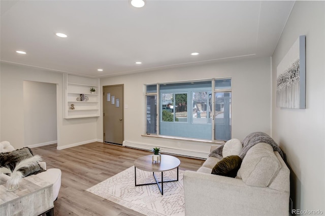 living room featuring baseboards, baseboard heating, wood finished floors, and recessed lighting