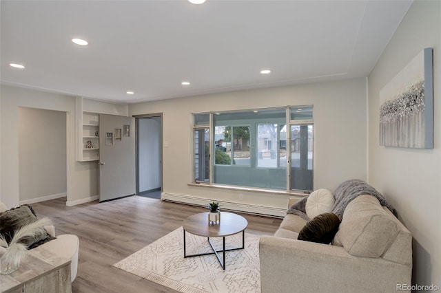 living area featuring baseboards, a baseboard radiator, wood finished floors, and recessed lighting